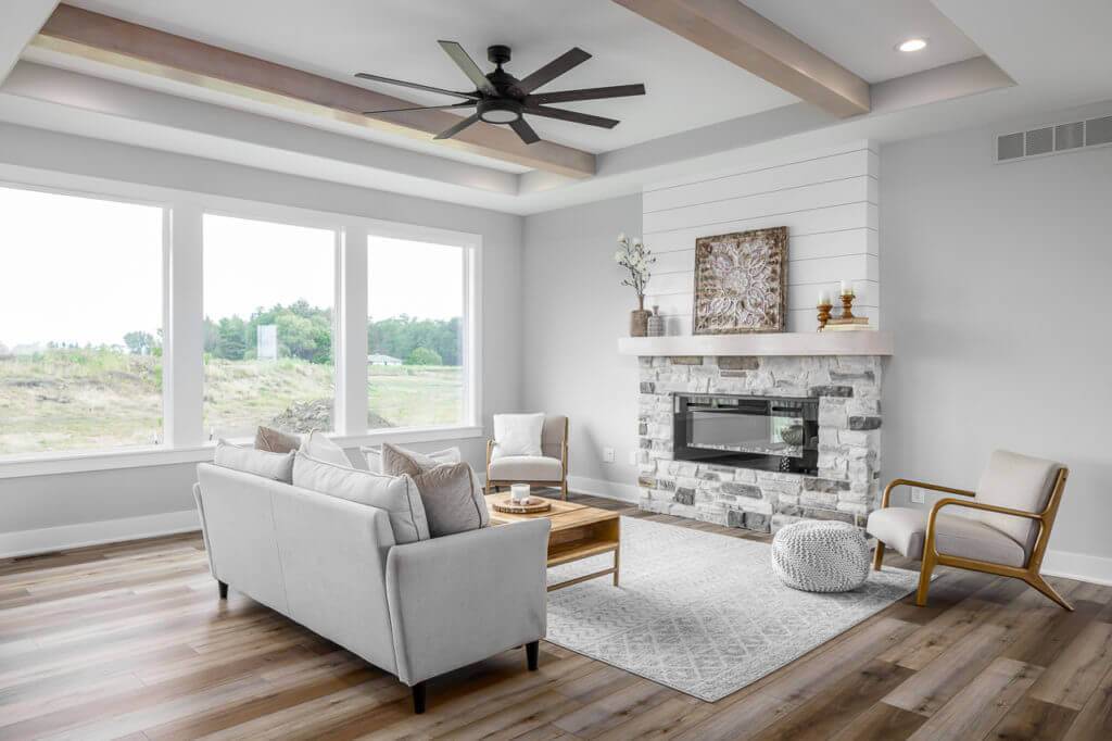 bright white living room with stone fireplace from KRM custom homes