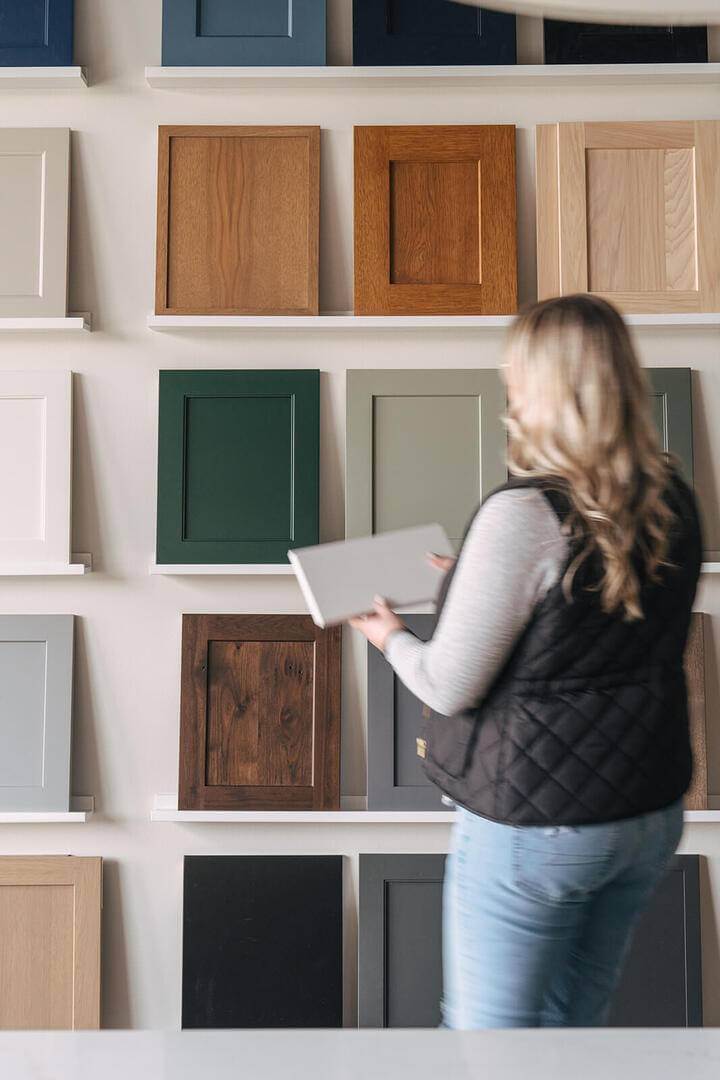 KRM custom homes client viewing cabinet colors for new home build.
